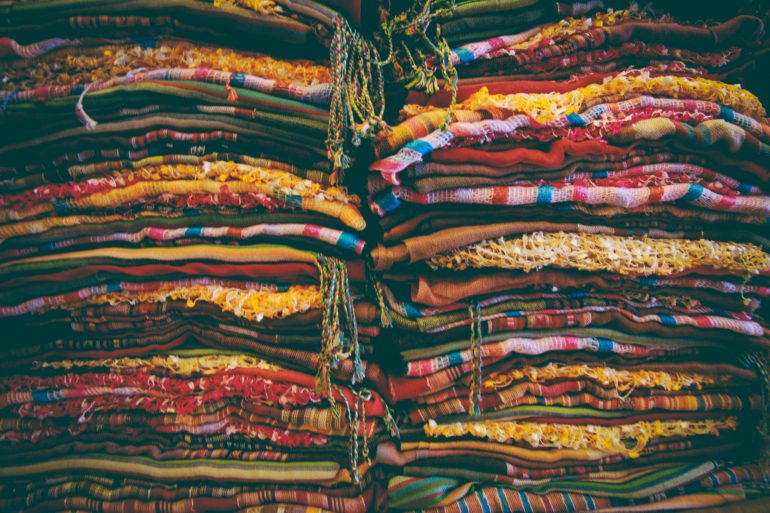 stacks of brightly colored fabric stacked high