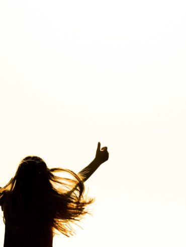 person holding arms up triumphantly